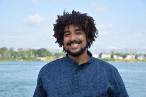 Marcus Rosten water ecology teacher smiles in front of river