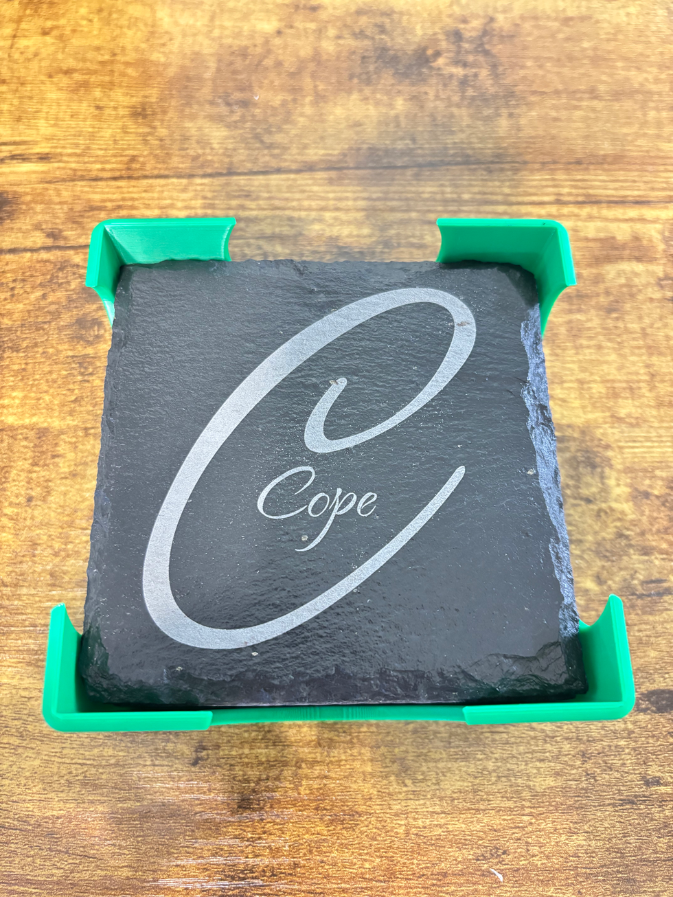 4 inch square slate coaster with a 3D printed coaster holder.