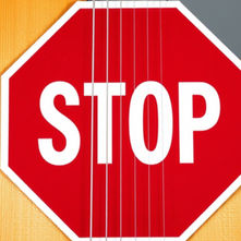Guitar with a stop sign over it