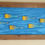 Thumbnail: fish art made with recycled materials scrap fence wood frame used paintbrushes resin brushes Ventana Surfboards