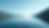 Close-up view of a serene lake reflecting a clear blue sky