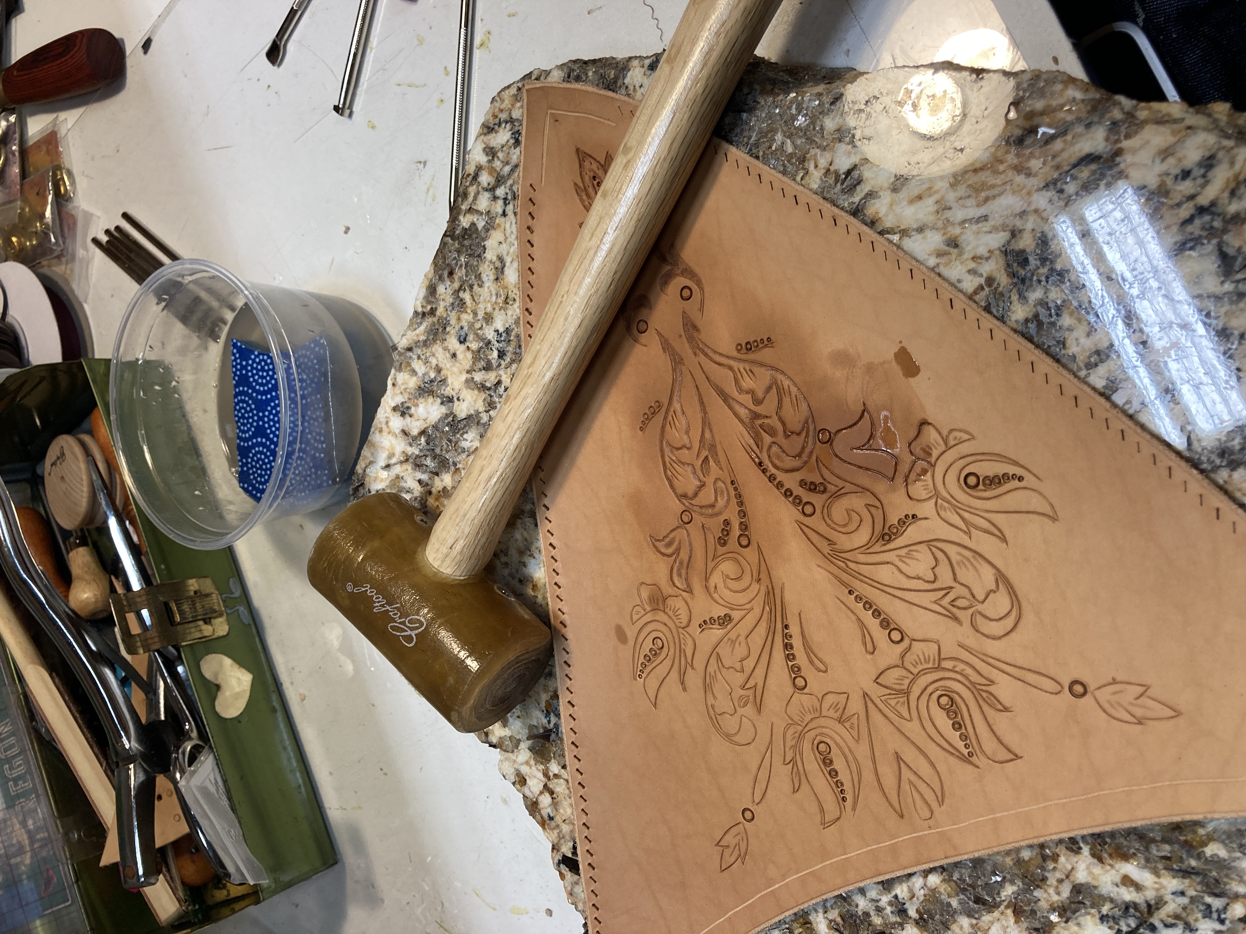 Leather tooling detail — draping and tailoring work