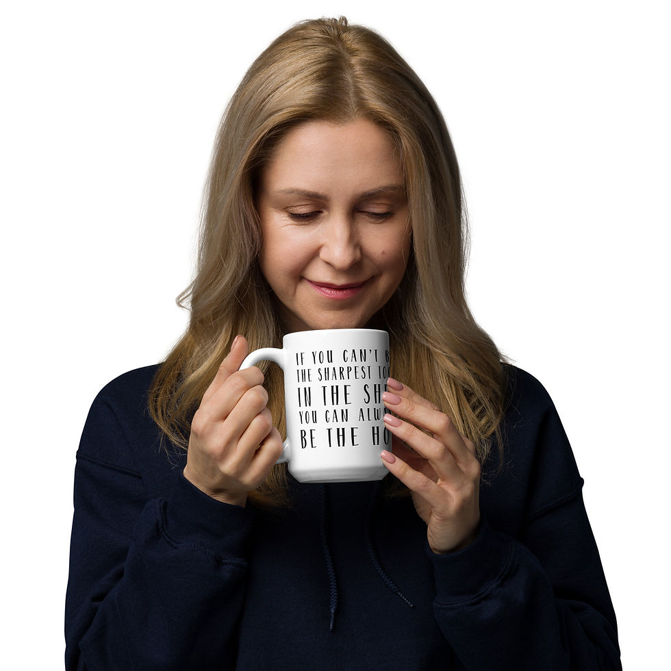Thumbnail: Model holding coffee mug with graphic saying it you can't be sharpest tool in the shed you can always be the hoe.