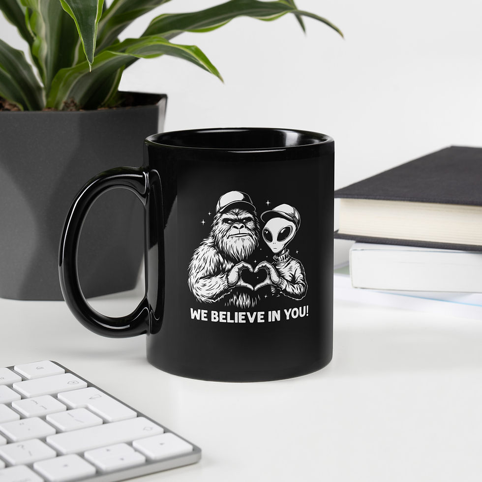 Thumbnail: Coffee mug with a graphic of bigfoot and alien saying we believe in you.