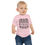 Thumbnail: Model wearing Bella Canvas baby t-shirt with graphic saying beware the smiling dm.