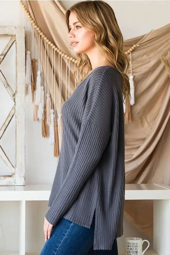 Thumbnail: Woman in gray long-sleeve top and blue jeans