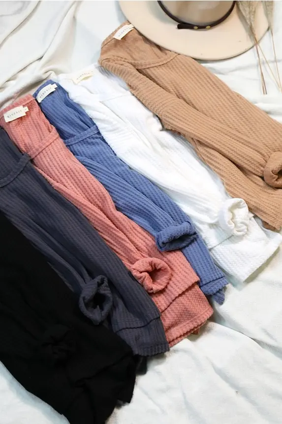 Thumbnail: Collection of folded wireless bralettes in various colors
