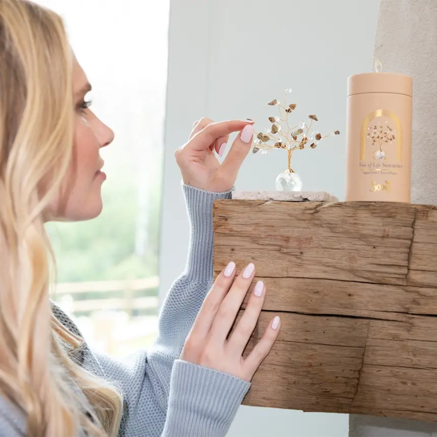 Thumbnail: Woman placing an object on a wooden mantel
