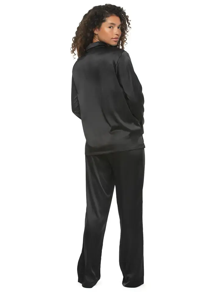 Thumbnail: Woman in black satin pajamas, back view
