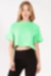 Woman in green cropped t-shirt and black pants