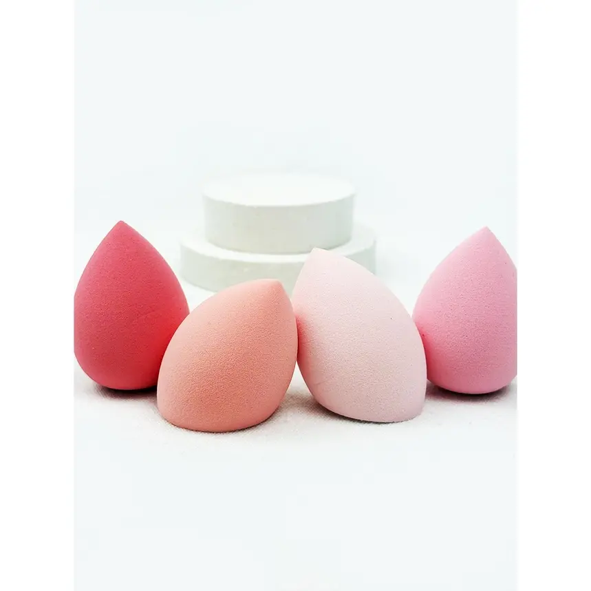 Four teardrop makeup sponges in shades of pink