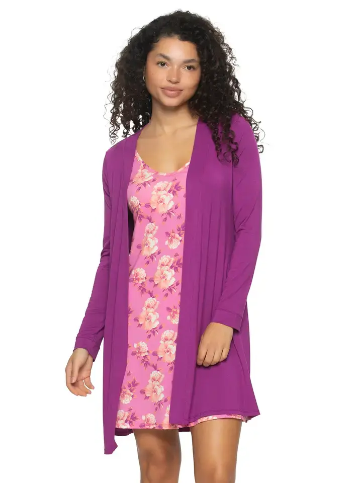 Thumbnail: Woman wearing a pink floral dress and purple cardigan