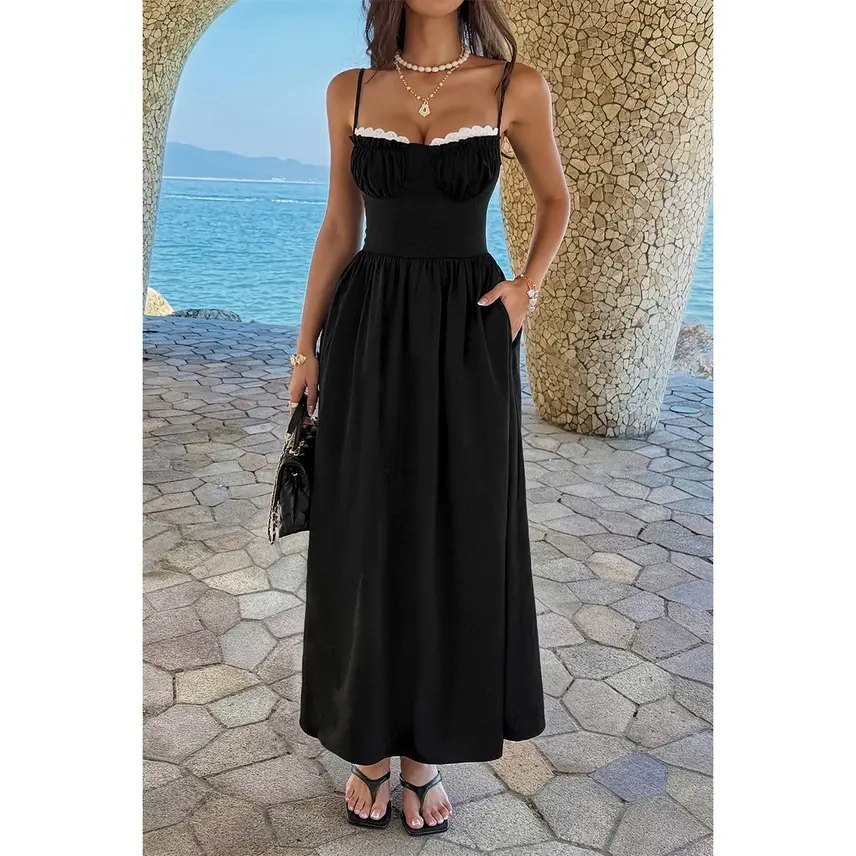 Woman wearing a black maxi dress with white trim
