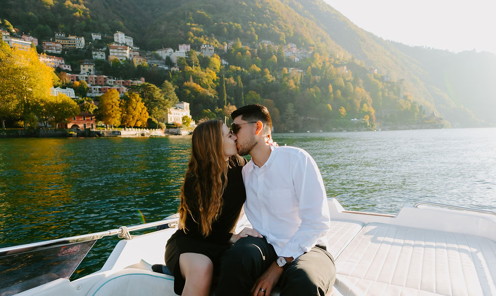 Couple kissing on a boat in Lake Como Italy