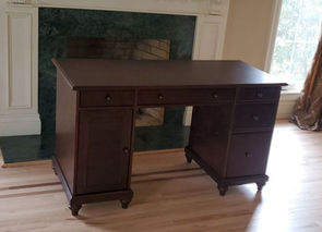 Assembled dark wood office desk with drawers