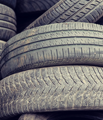 Crumb rubber from  old tyres used to replace a certain proportion of the sand typically mixed. 