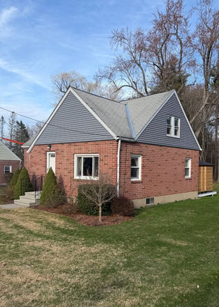 Weathered asphalt roof on a Fitchburg Cape before replacement
