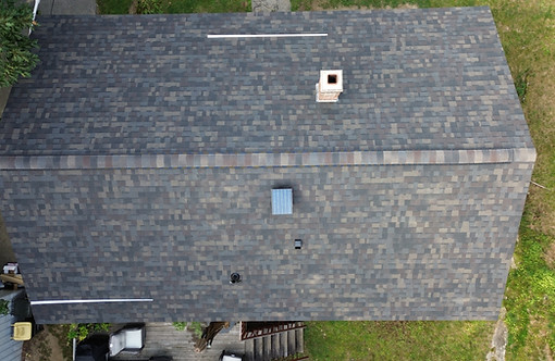 Top-down drone view of a completed architectural shingle roof replacement in Winchendon MA