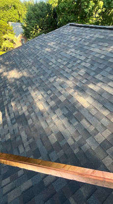 Close-up of a single copper valley running down an Owens Corning Duration shingle roof in Worcester, MA