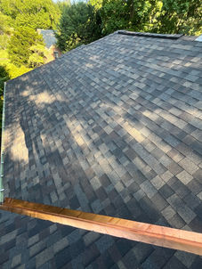 Wide view of Owens Corning Duration shingles with copper valley flashing along the roof edge, Worcester, MA