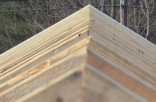 Perfectly aligned and reinforced new wood truss framing on a historic barn restoration project in Spencer, MA.