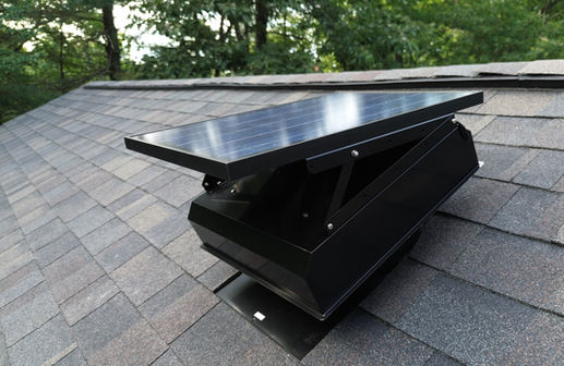Close-up of a roof-mounted solar attic fan installed on an architectural shingle roof in Winchendon, MA.