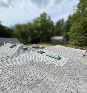 Completed Templeton, MA skylight repair with proper flashing and closely matched asphalt shingles.