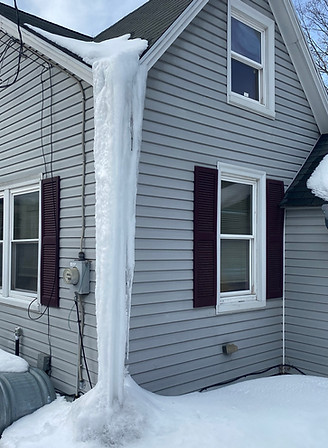 Large ice dam removed from roof edge down to ground level on a home in Marlborough, MA