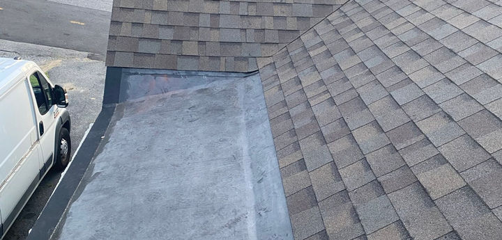 Black EPDM rubber roof installation on a low-slope residential roof section in Leominster, MA.