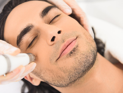 Young man enjoying cavitation facial peeling.jpg