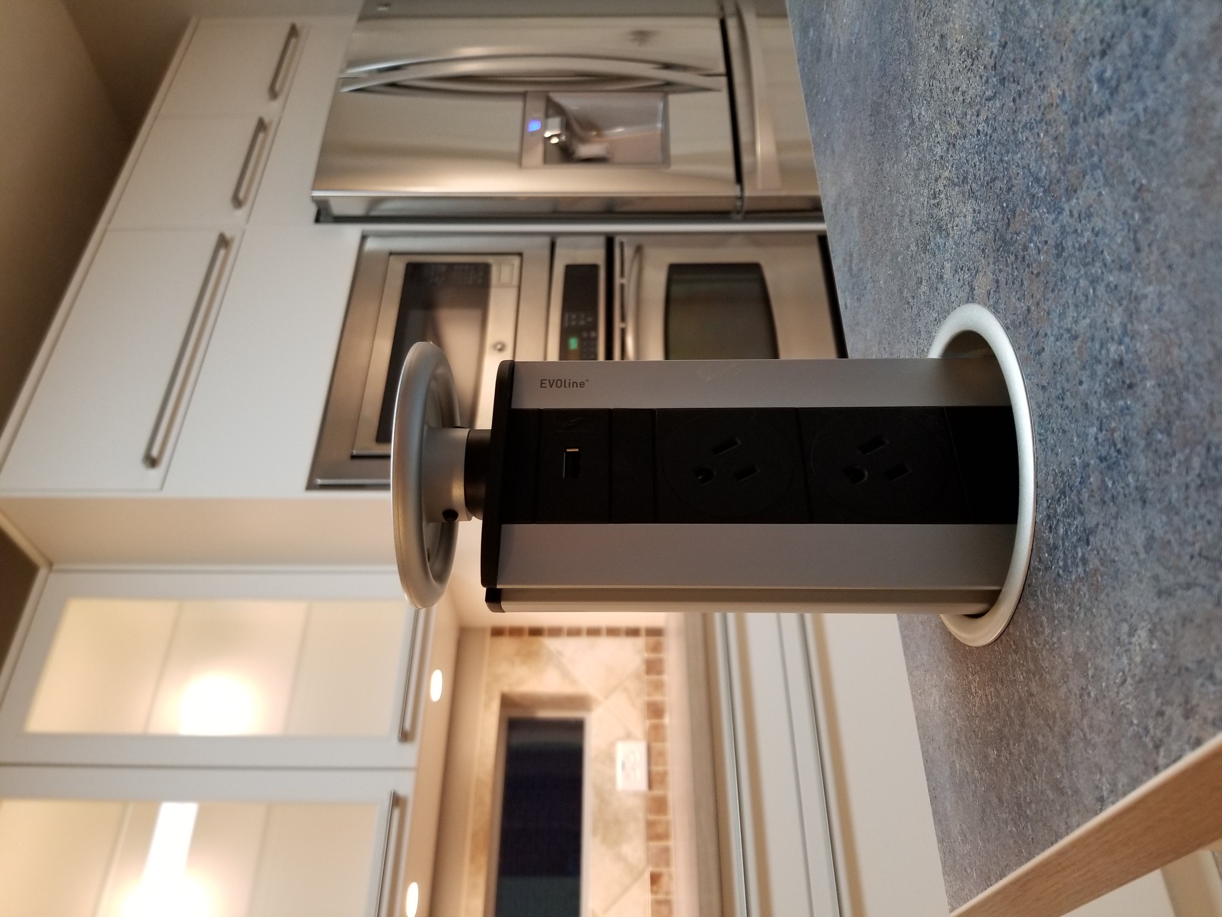 Kitchen with retractable outlet