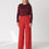 Thumbnail: Front view Bièl pants Radiant Red in merino wool by Floria Collective on mature model