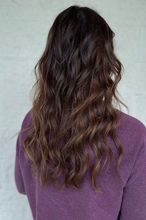Long, wavy brunette with some lighter brown highlights, hair extensions