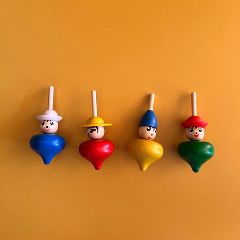 Four colorful wooden spinning tops
