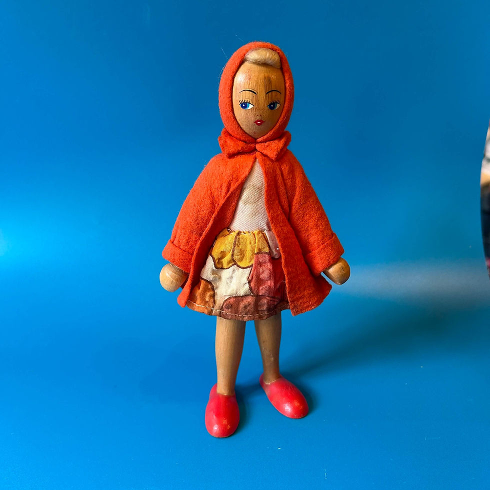 Vintage wooden doll in red coat