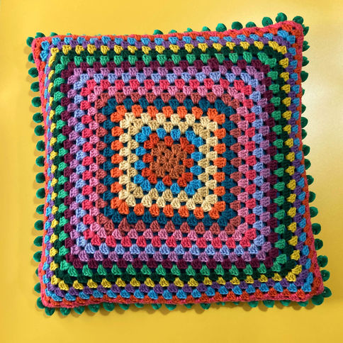 Colorful crochet cushion with granny square pattern