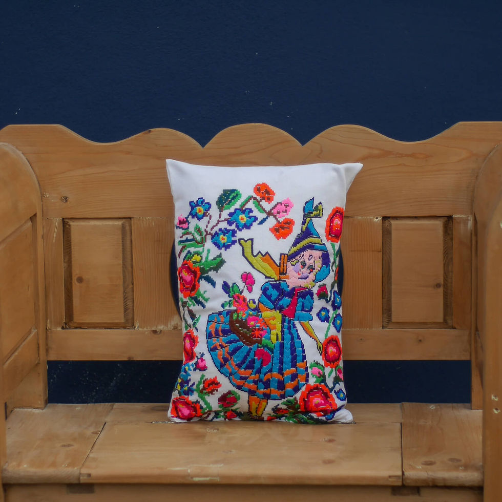 Embroidered girl pillow on wooden bench