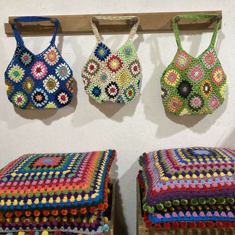Colorful crocheted bags and cushions
