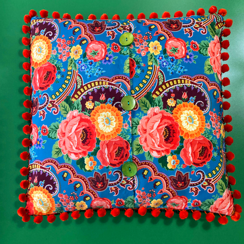 Floral square cushion with pom-poms