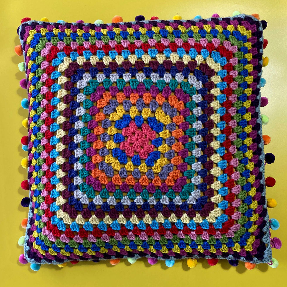 Colorful crochet granny square cushion