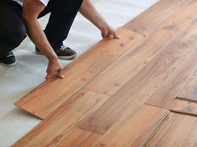 homeguide-contractor-installing-laminate-flooring-on-underlayment.jpg