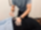 Chiropractor adjusting patient's low back with integrator