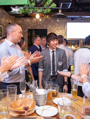 Men applauding magician at lively Singapore event