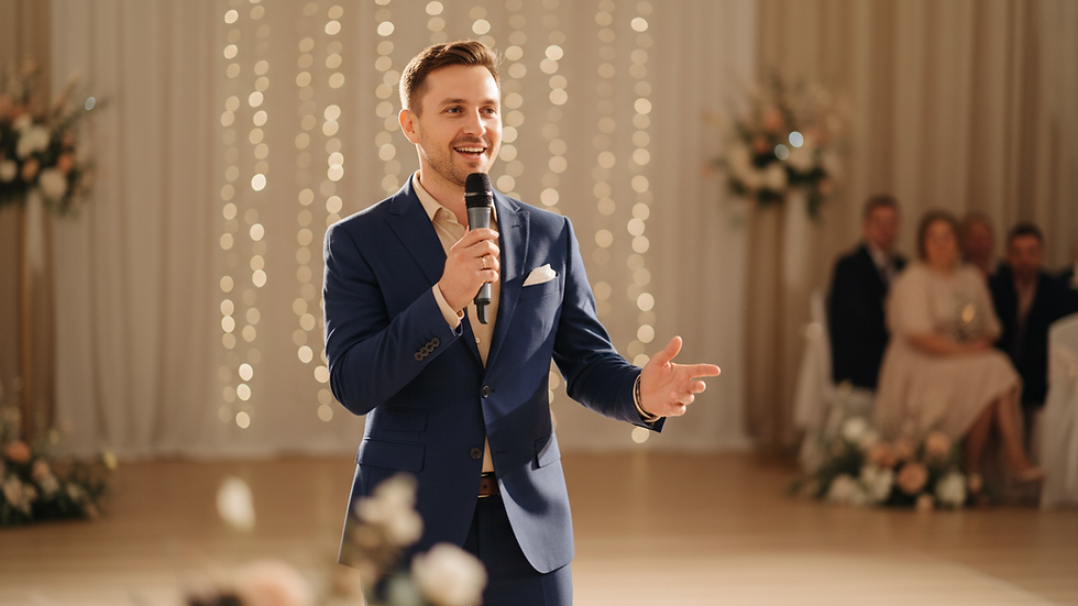 Eye-level view of a wedding emcee holding a microphone on stage