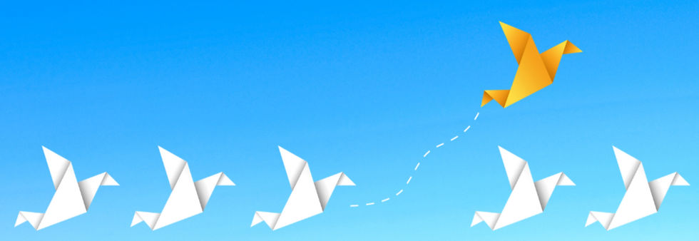 Blue sky with white paper birds flying and a yellow paper bird breaking away from the group.