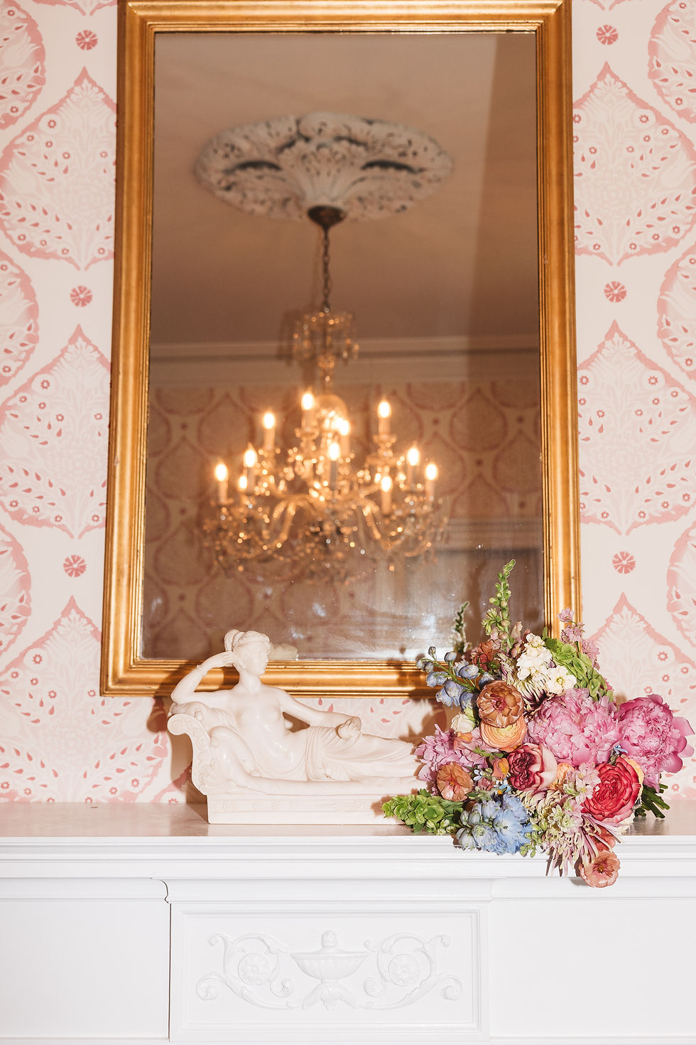 Details shot of getting ready space with mirror, chandelier, small statue, and flowers. Wedding day at Bellevue Hall in Wilmington, DE. Photographed by South Jersey, Philly based wedding photographer Madison Neumann Photography.