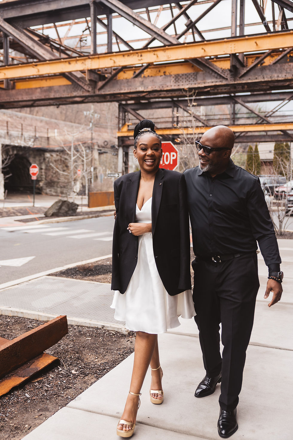 Future bride and groom take a stroll outside, smiling, newly engaged. Engagement session at Lark in Bala Cynwyd, PA, photographed by South Jersey, Philadelphia based wedding photographer Madison Neumann Photography.