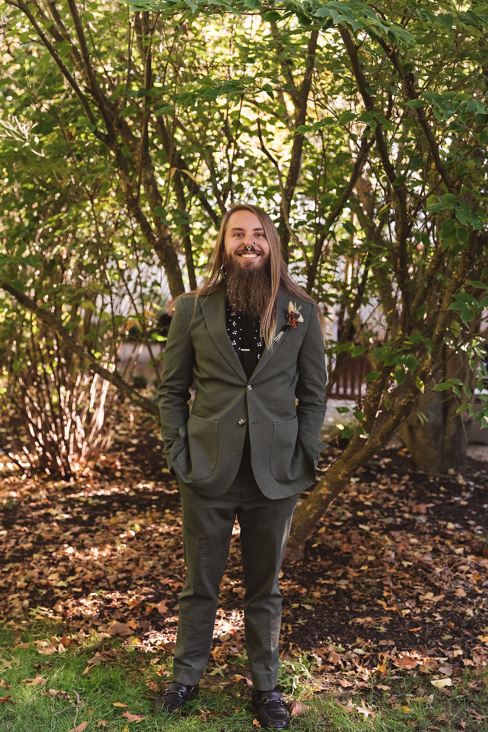 Groom photographed on his fall wedding day at The Grain House in Basking Ridge, NJ. The groom wears green and black. Photographed by NJ wedding photographer Madison Neumann Photography.