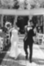 Guests blow bubbles as bride and groom walk together down the aisle after saying "I Do." April wedding day at The Waterfall in Claymont, DE. Photographed by South Jersey, Philly based wedding photographer Madison Neumann Photography.