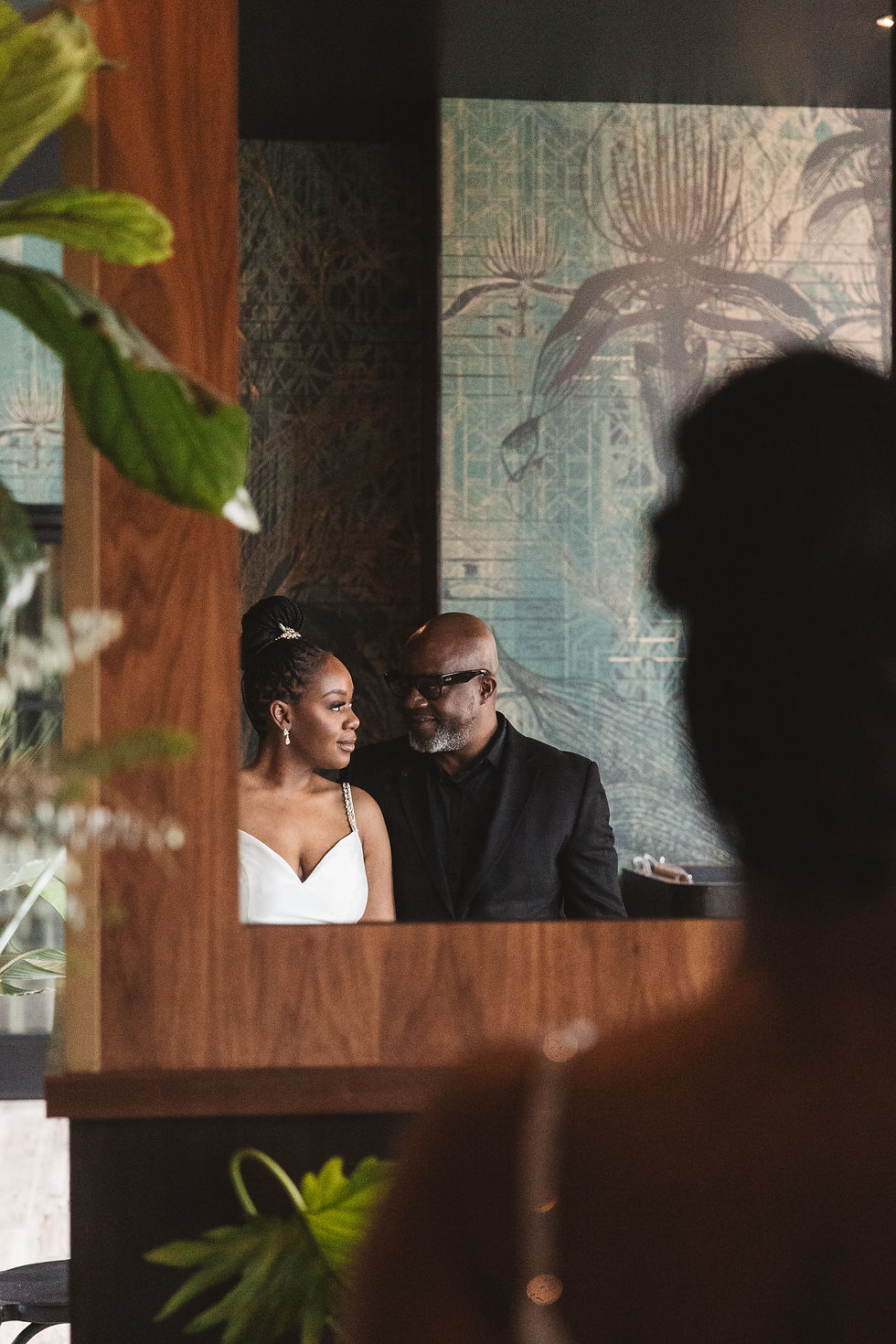 Future bride and groom look at each other in reflection of mirror. Engagement session at Lark in Bala Cynwyd, PA, photographed by South Jersey, Philadelphia based wedding photographer Madison Neumann Photography.